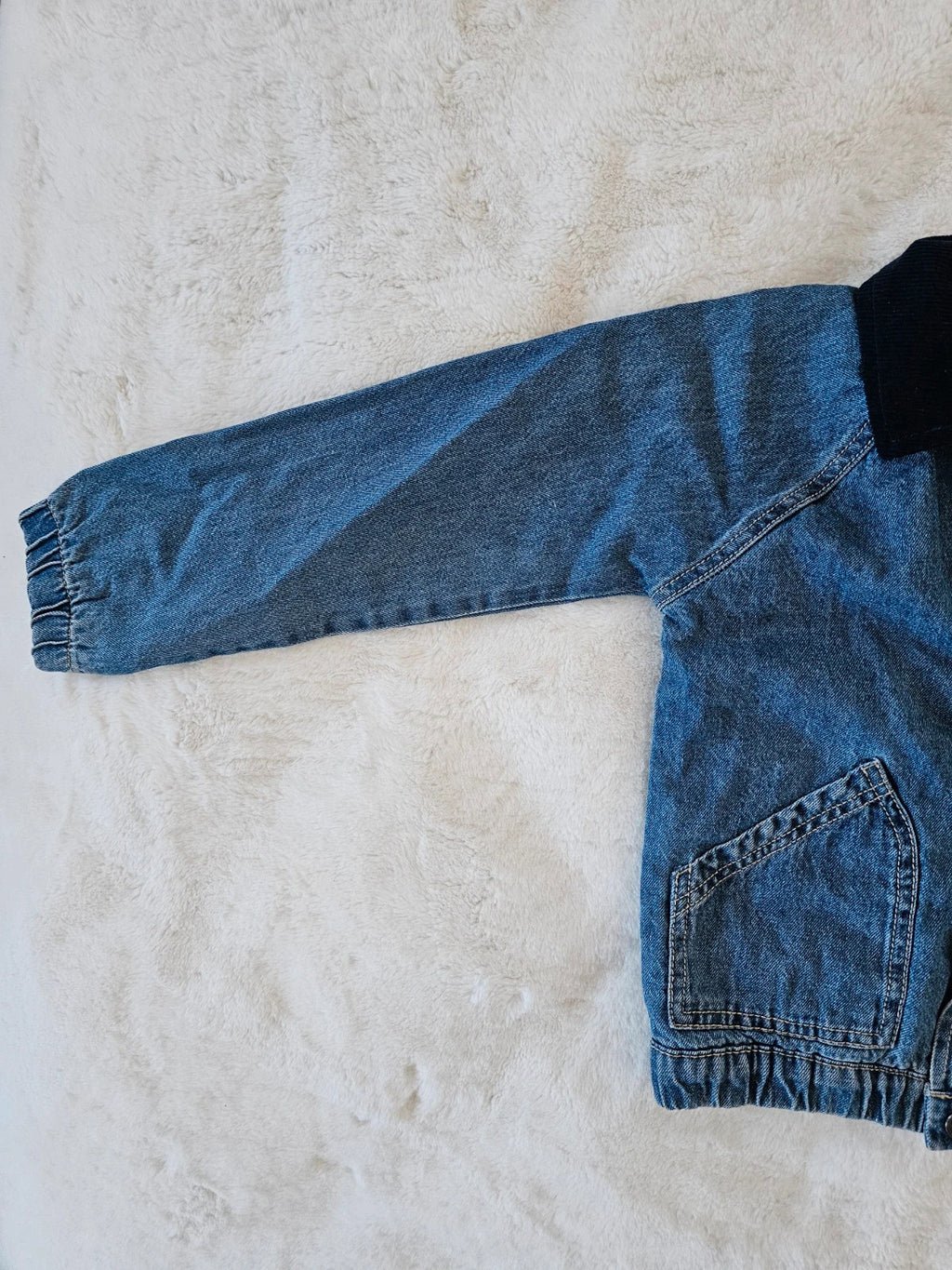 TU Kids blue denim sherpa jacket with outer collar, buttons, and pockets.