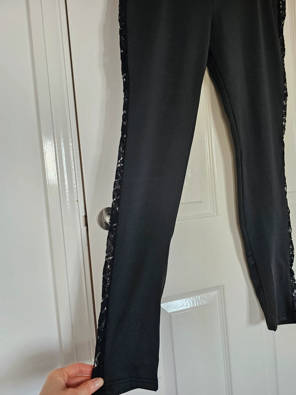 SHEIN black high rise leggings with lace patchwork and hollow stitching details.
