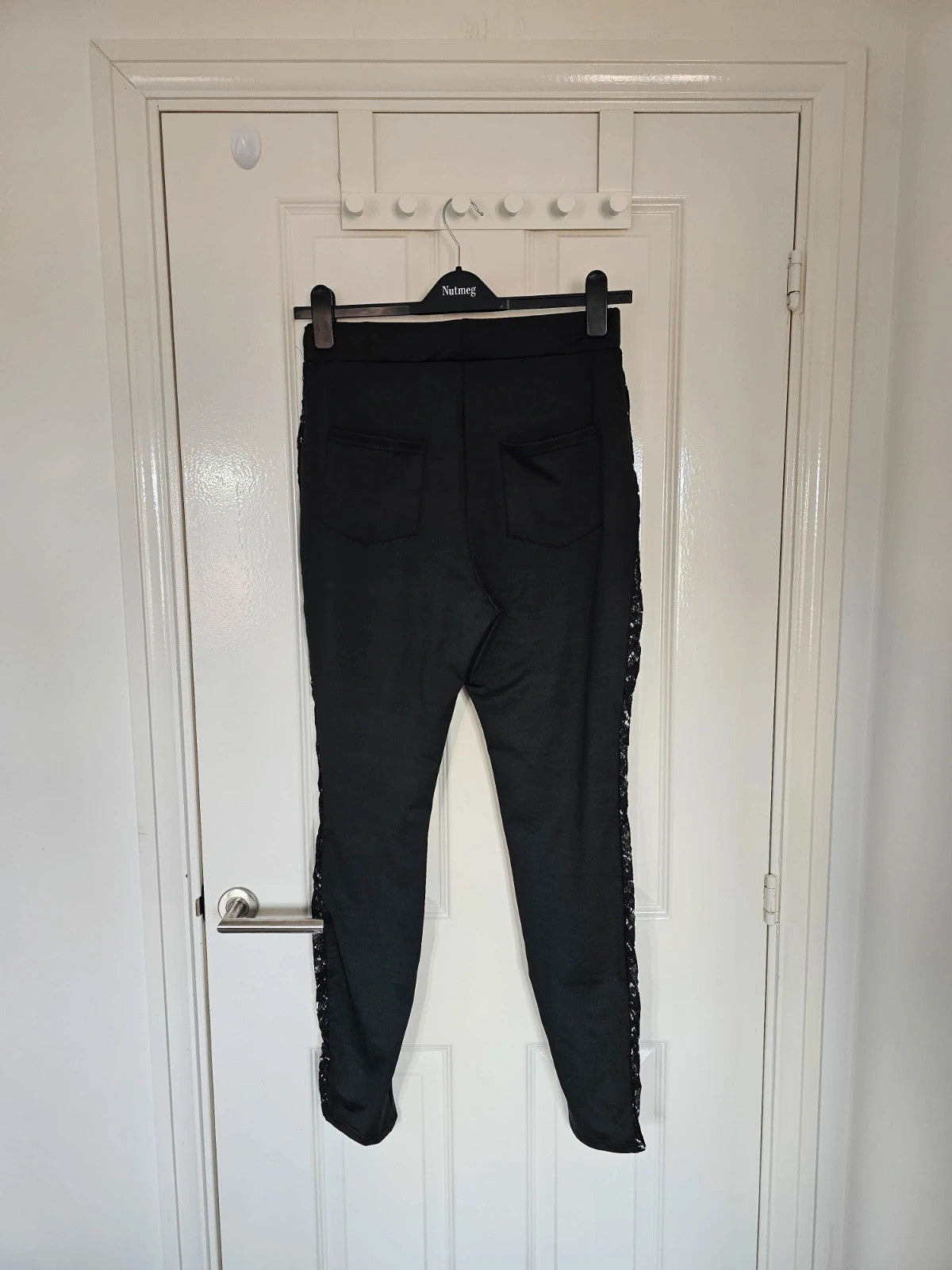 SHEIN black high rise leggings with lace patchwork and hollow stitching details.