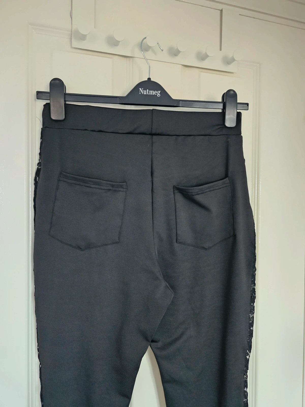 SHEIN black high rise leggings with lace patchwork and hollow stitching details.