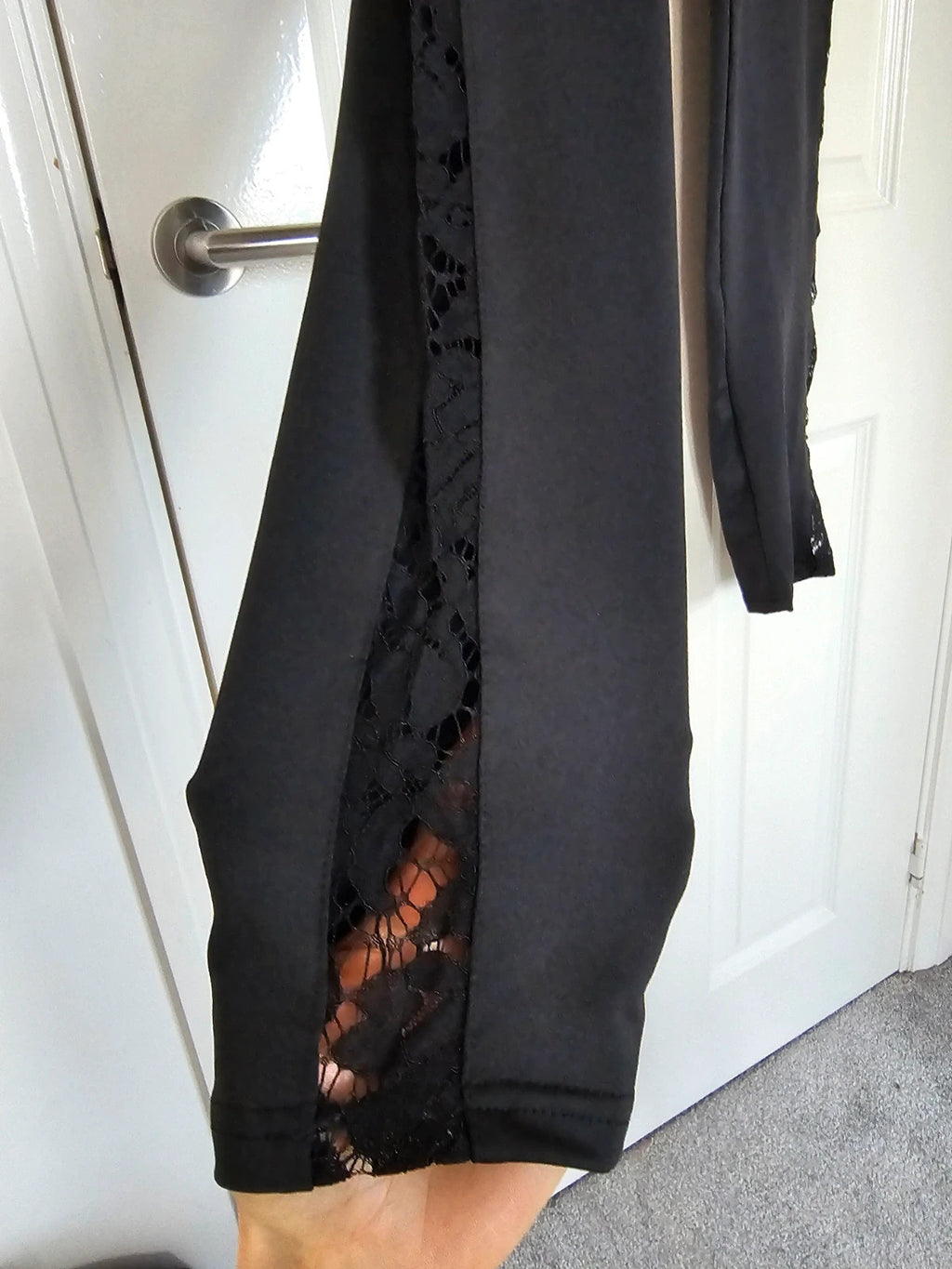 SHEIN black high rise leggings with lace patchwork and hollow stitching details.