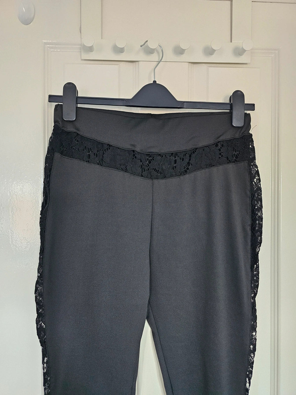 SHEIN black high rise leggings with lace patchwork and hollow stitching details.