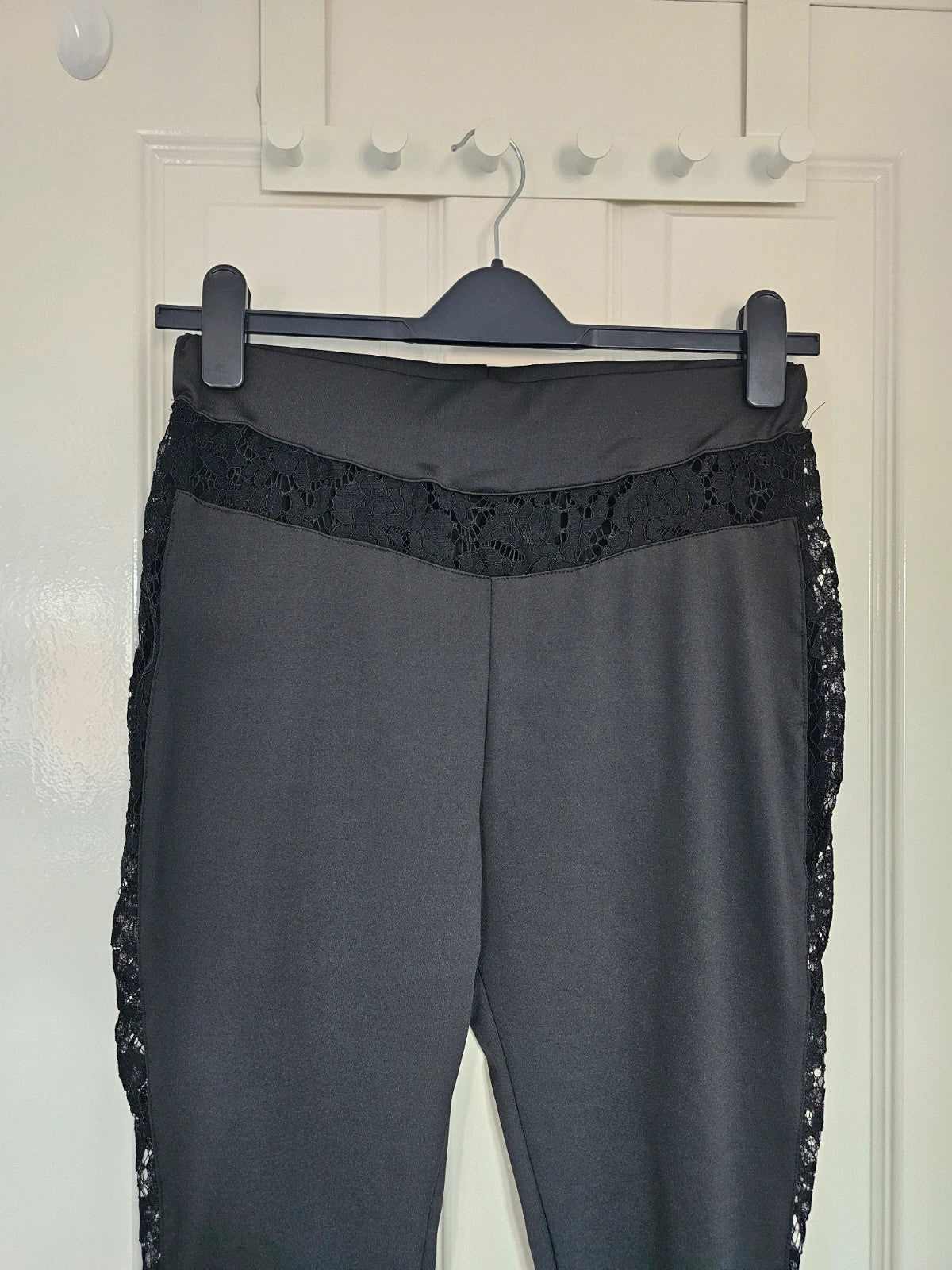 SHEIN black high rise leggings with lace patchwork and hollow stitching details.