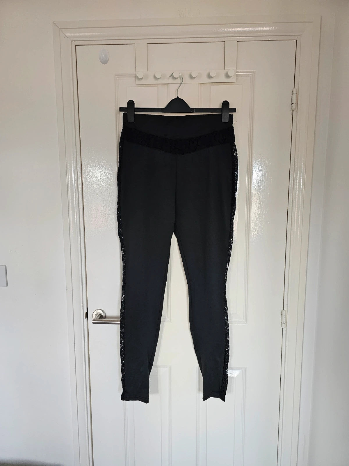 SHEIN black high rise leggings with lace patchwork and hollow stitching details.