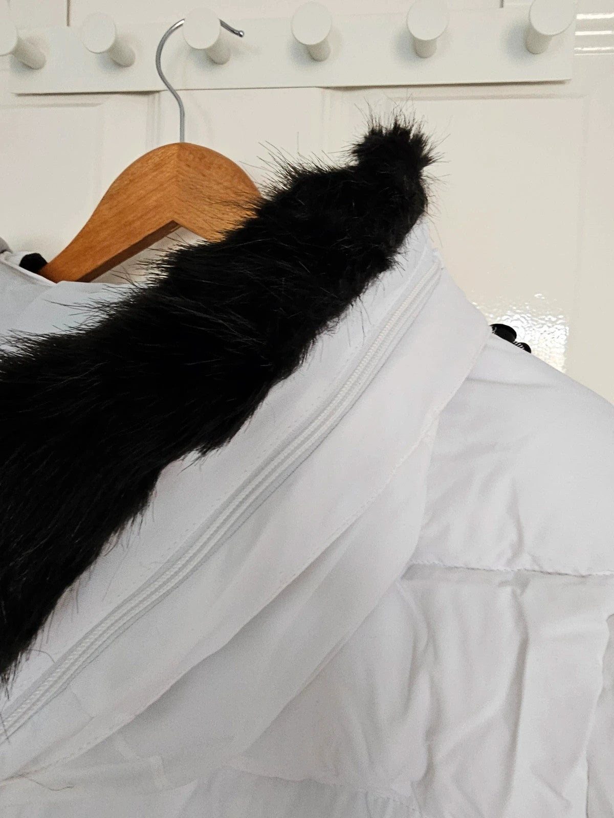 Dare2b white ski jacket with removable faux-fur hood, adjustable hem, and multiple pockets.