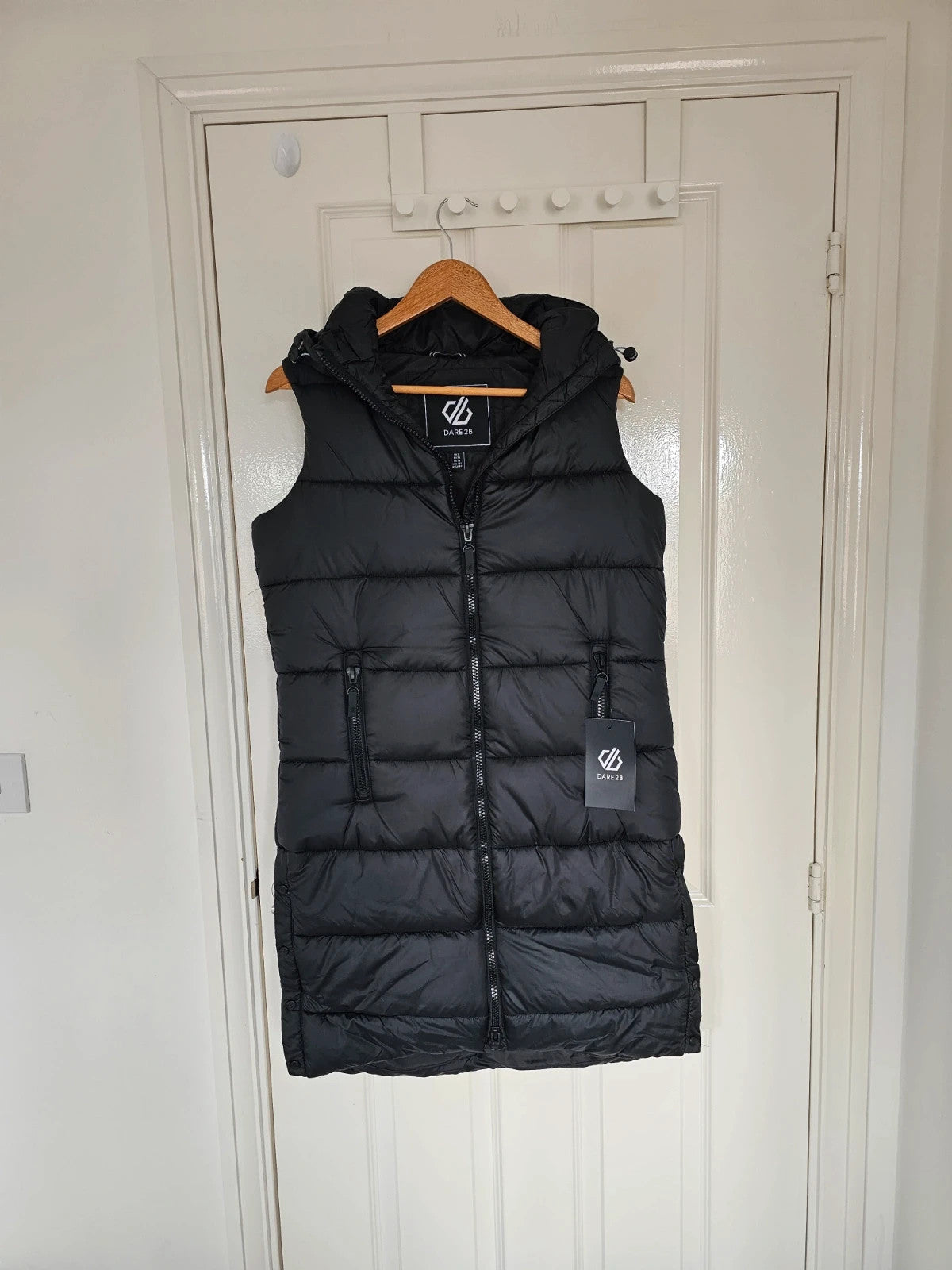 Dare2b black longline hooded puffer gilet with zipper, waterproof and windproof design.