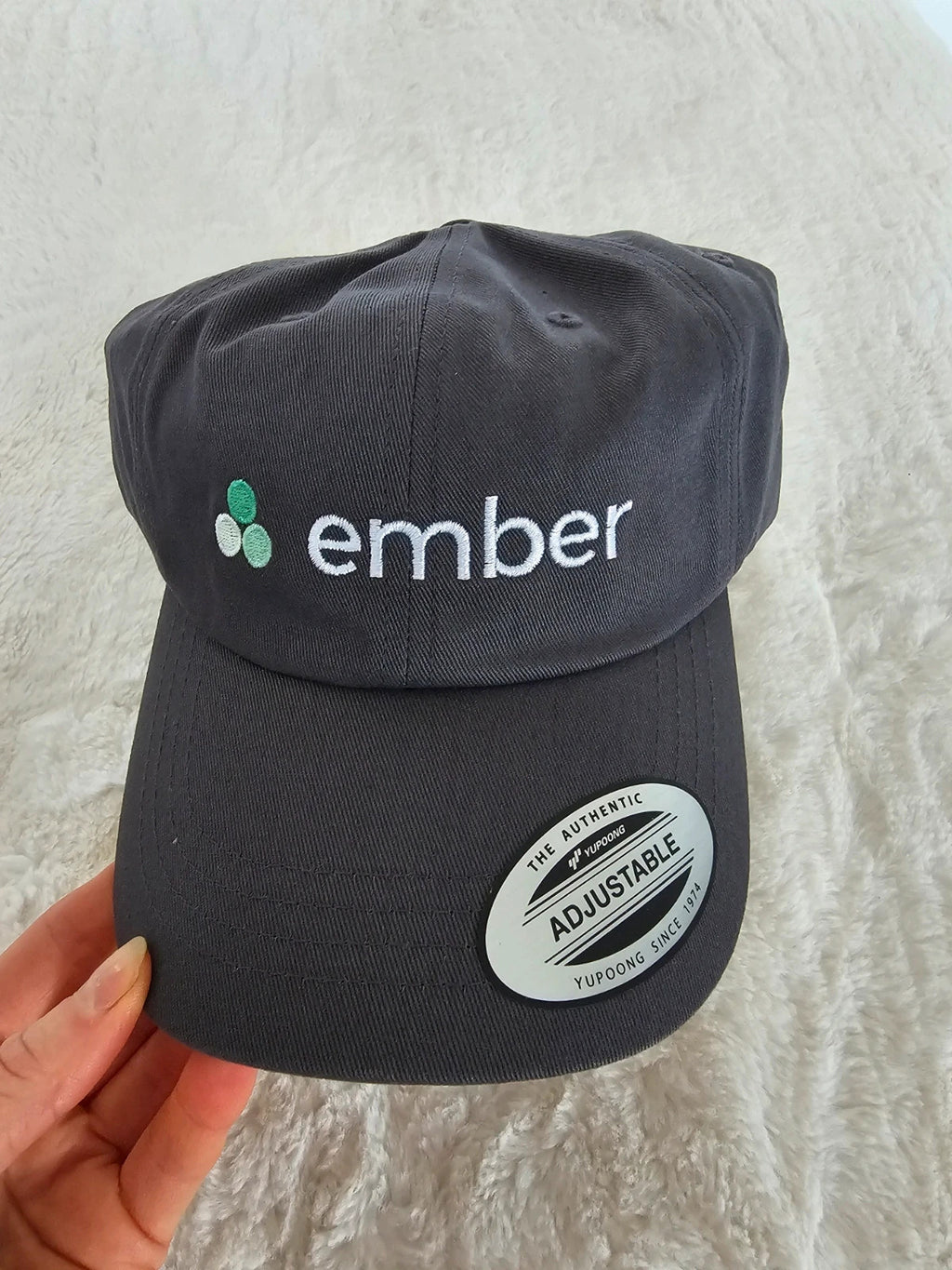 The Classics grey dad hat adjustable straps embroidered logo cotton material.