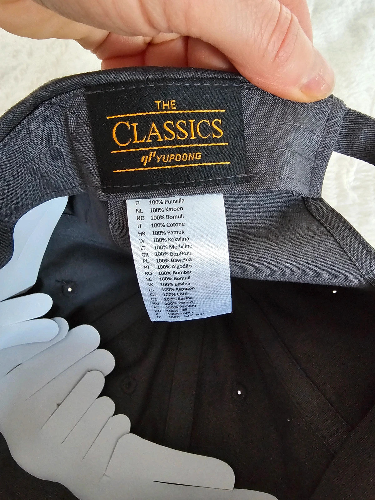 The Classics grey dad hat adjustable straps embroidered logo cotton material.