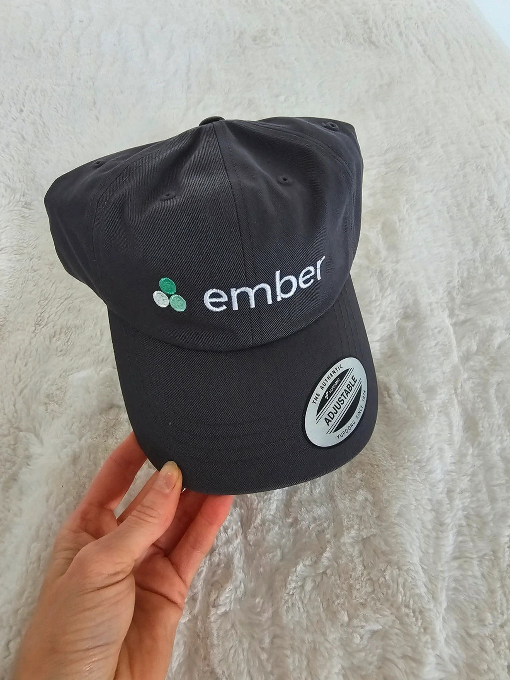 The Classics grey dad hat adjustable straps embroidered logo cotton material.