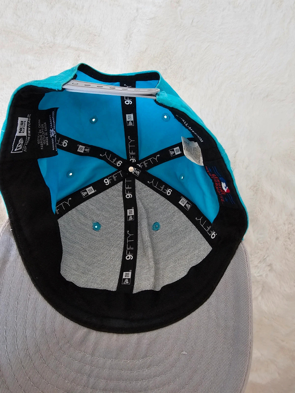 New Era blue snapback cap with NY logo applique and adjustable cotton straps.