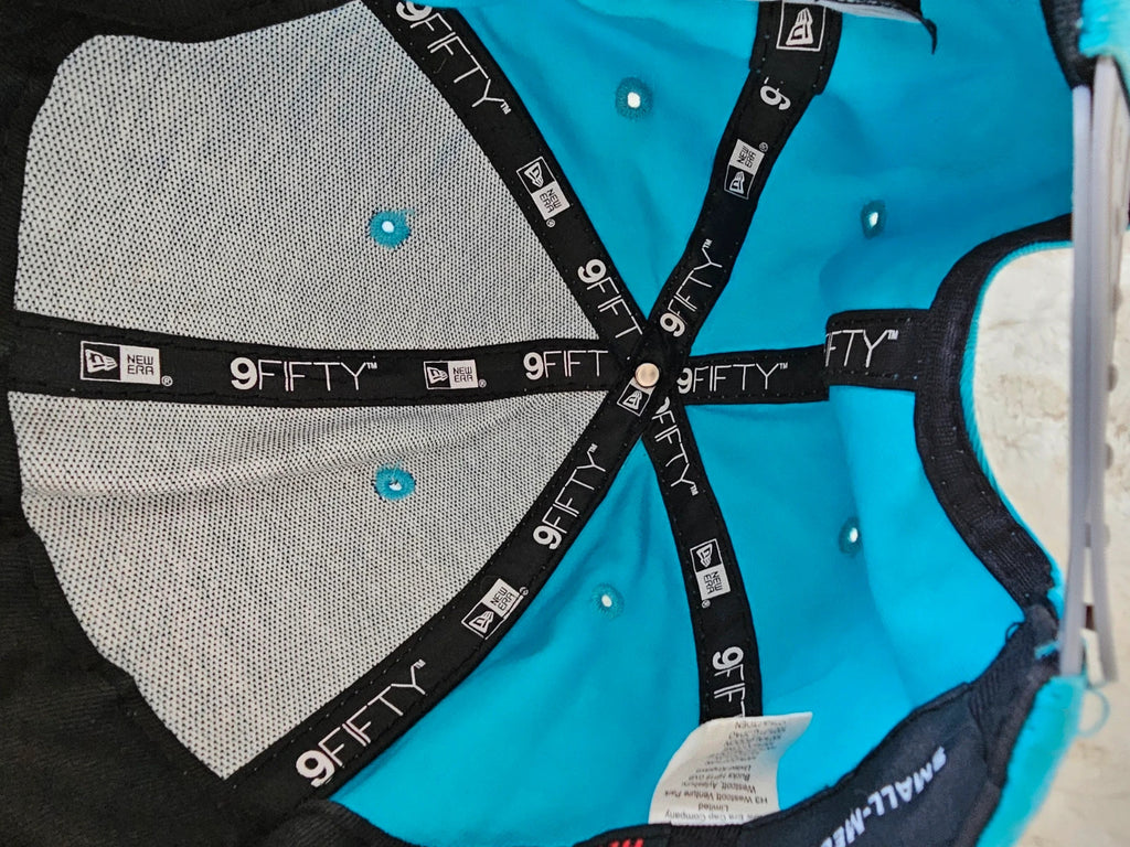 New Era blue snapback cap with NY logo applique and adjustable cotton straps.