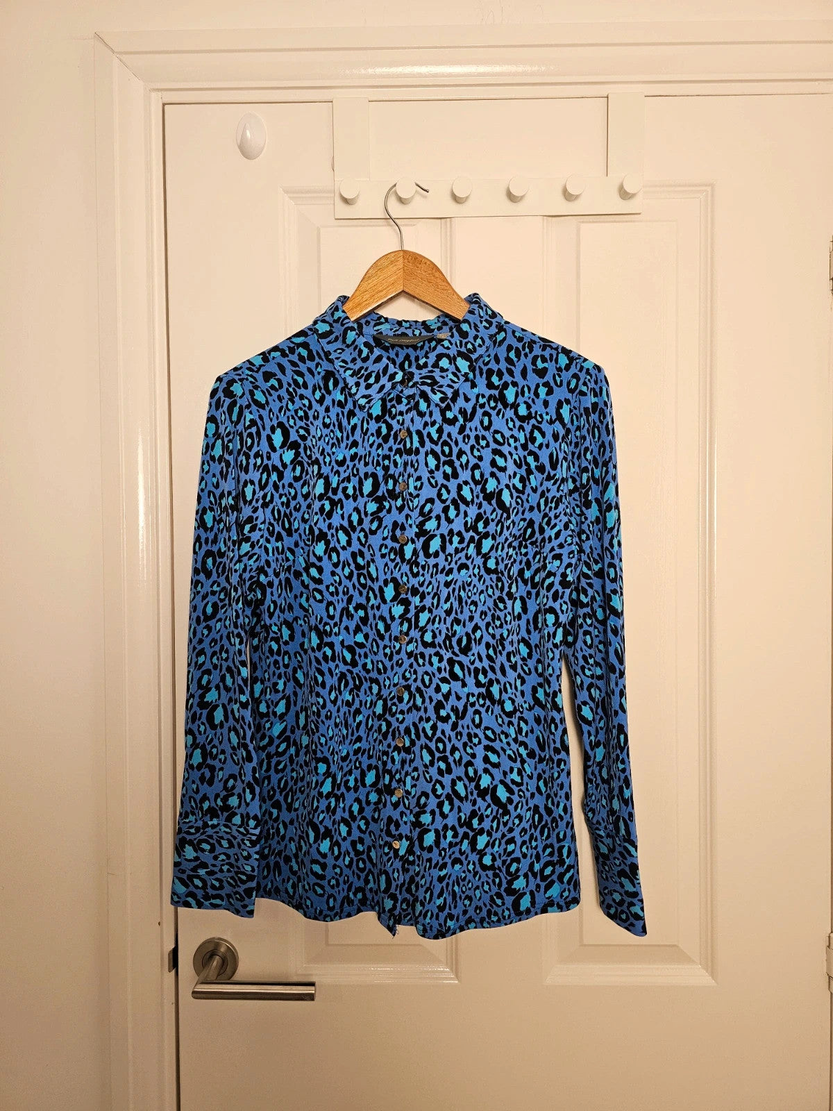 Ruth Langsford blue and black leopard print blouse with collar and button details.
