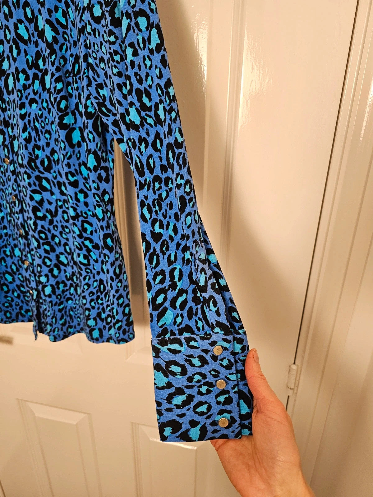 Ruth Langsford blue and black leopard print blouse with collar and button details.