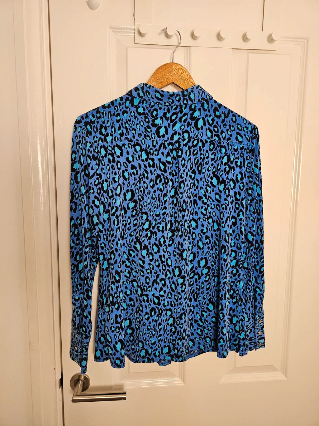 Ruth Langsford blue and black leopard print blouse with collar and button details.