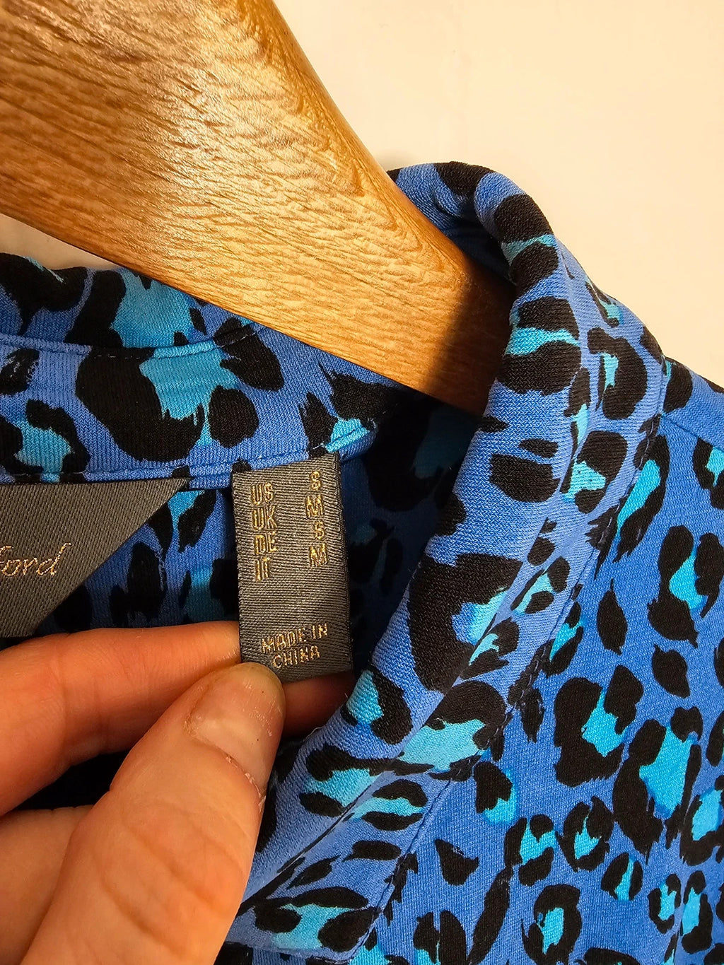 Ruth Langsford blue and black leopard print blouse with collar and button details.