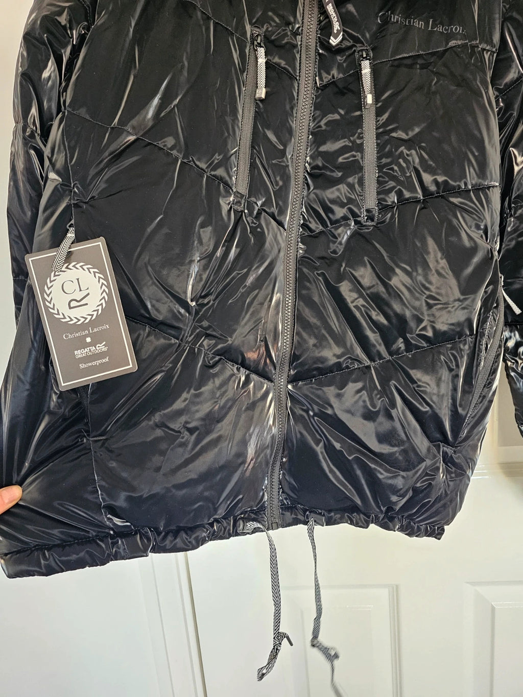 Christian Lacroix black puffer jacket quilted design with waterproof finish and inner pocket.