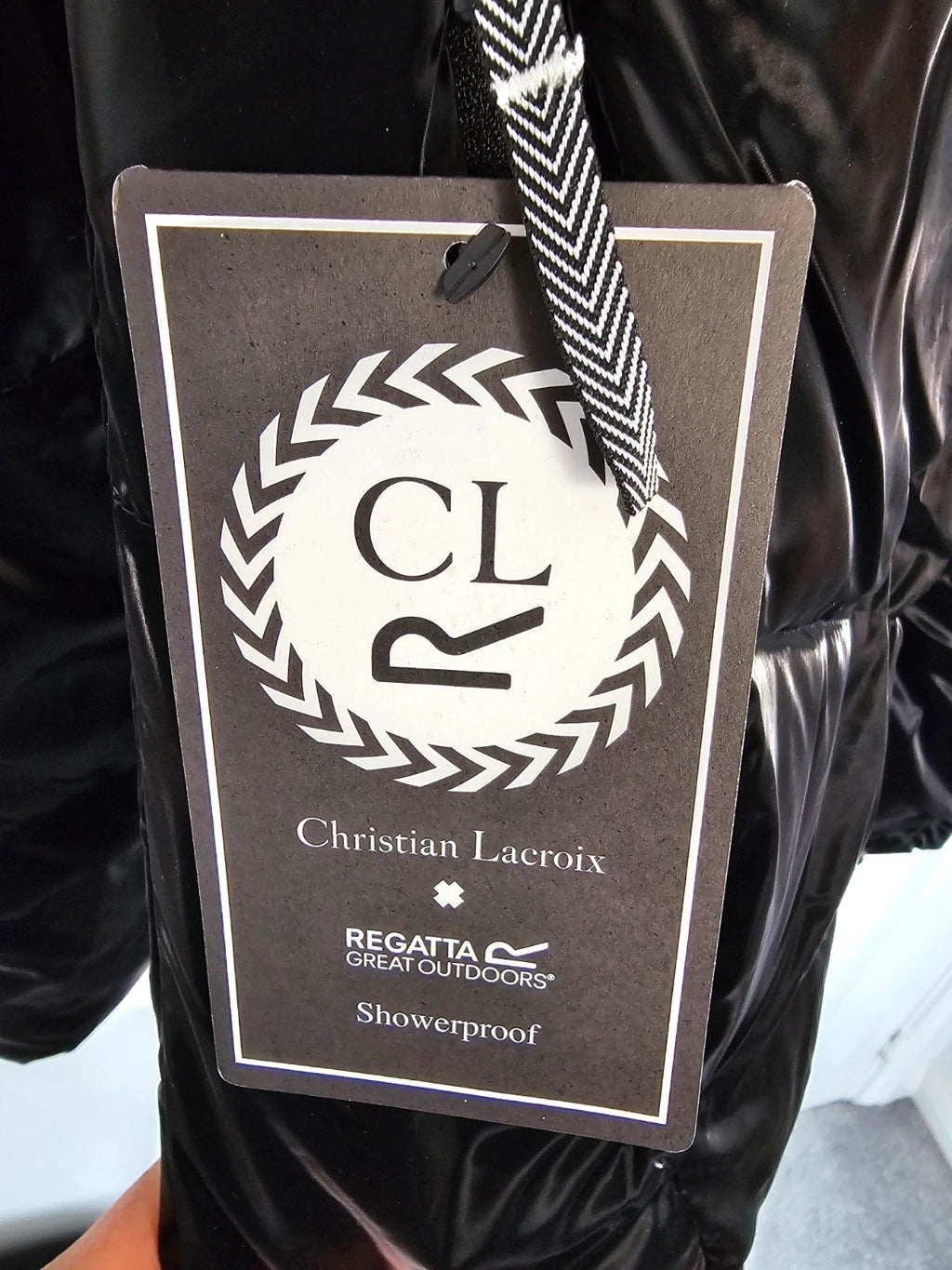 Christian Lacroix black puffer jacket quilted design with waterproof finish and inner pocket.