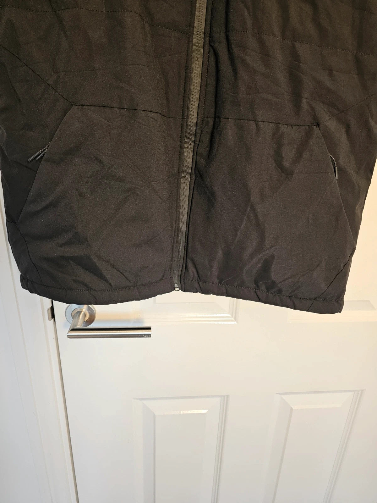 Generic black heating gilet sleeveless jacket with USB electric feature, thermal material.
