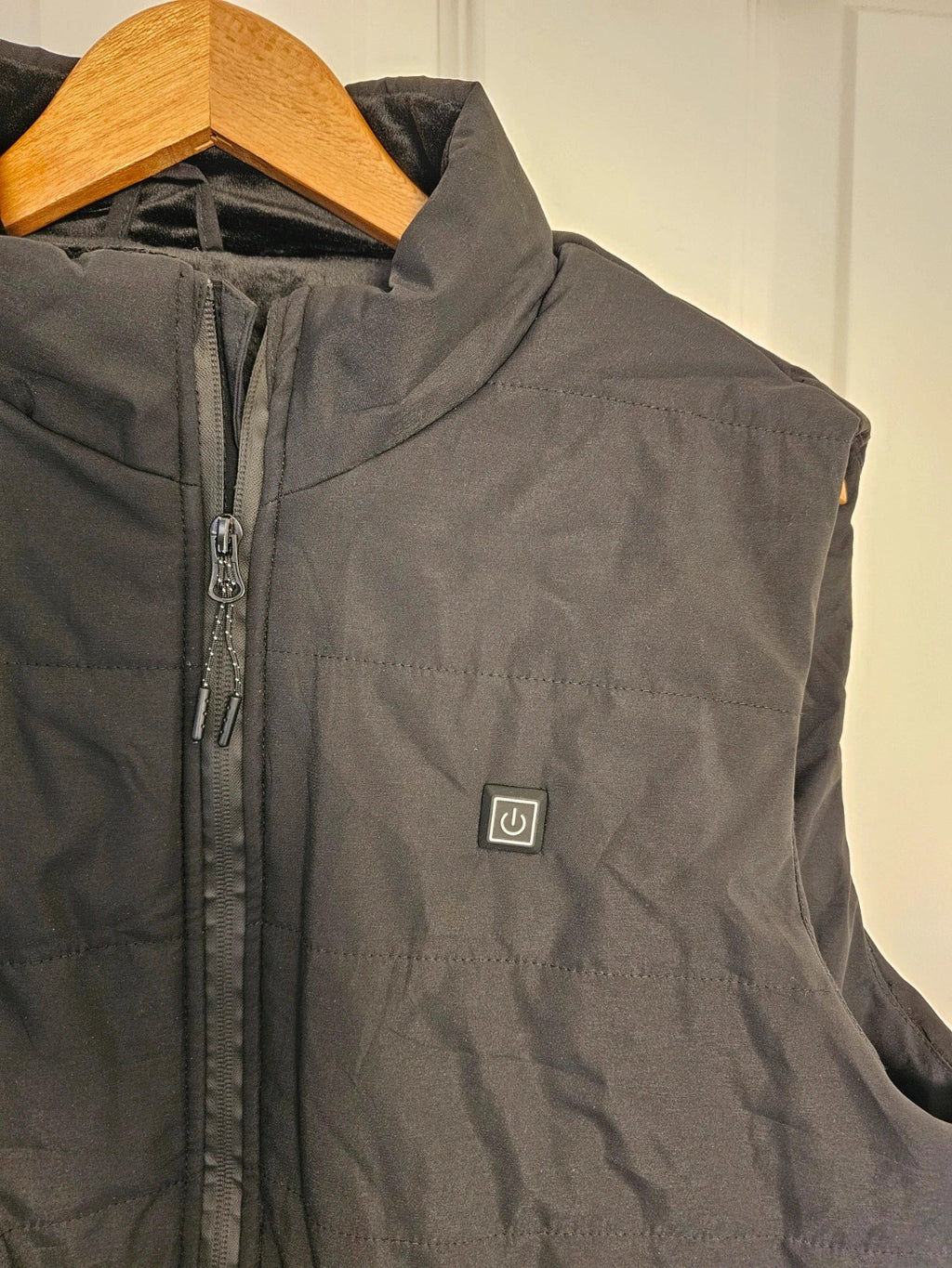 Generic black heating gilet sleeveless jacket with USB electric feature, thermal material.