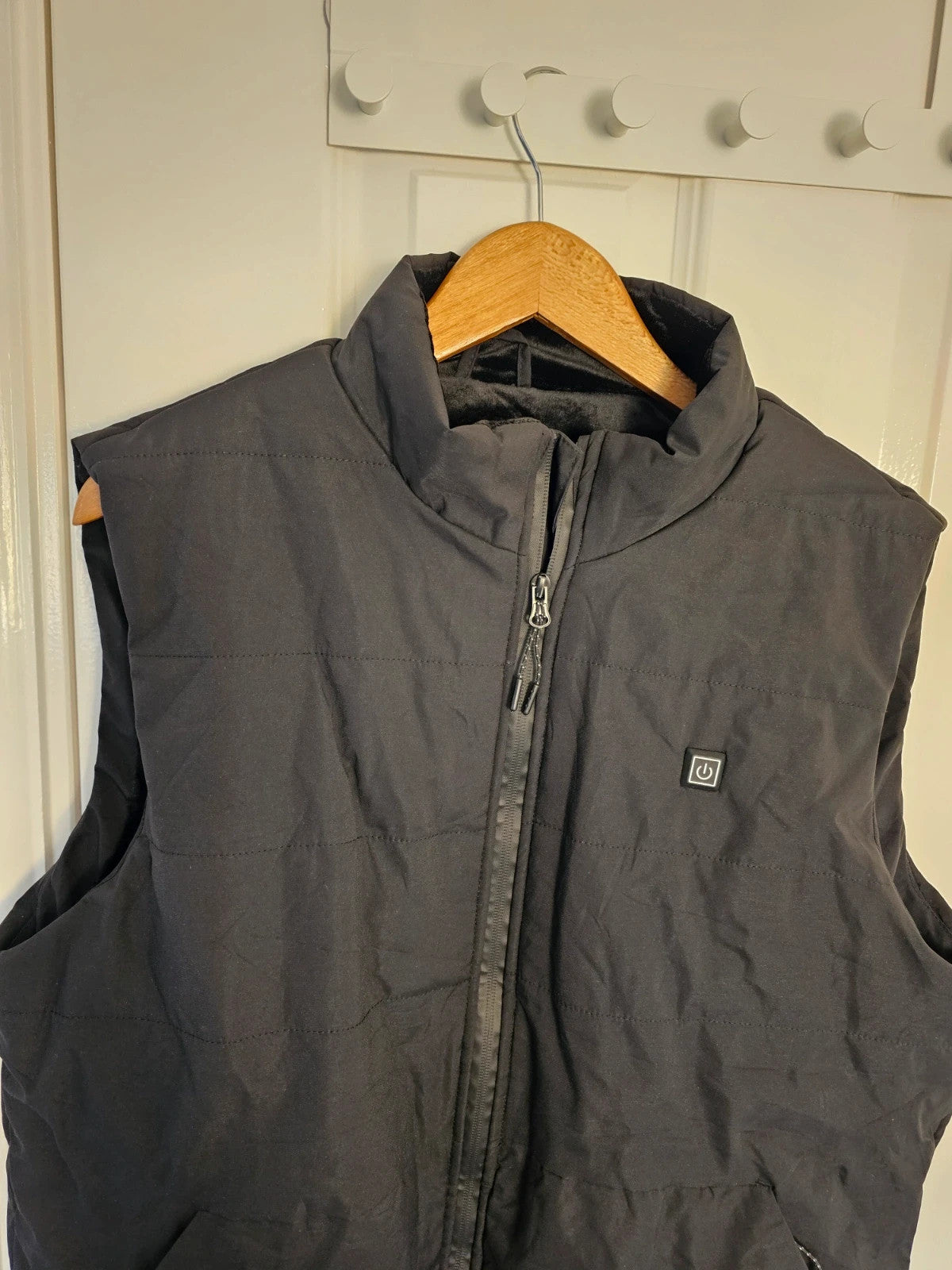 Generic black heating gilet sleeveless jacket with USB electric feature, thermal material.