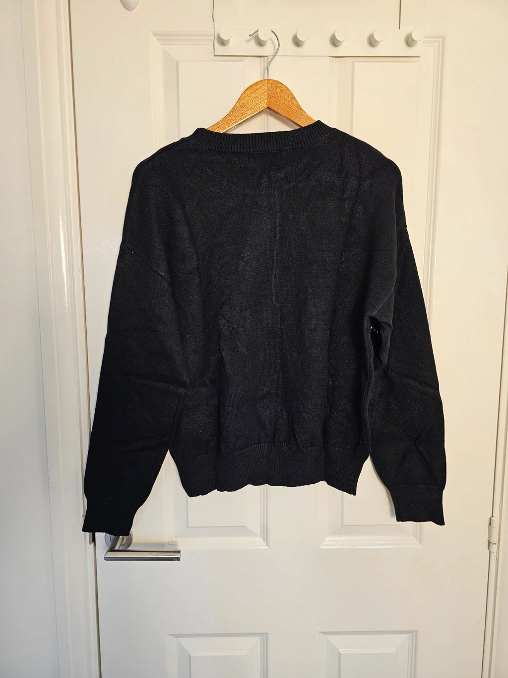 SHEIN black knit jumper with pearl studs and crew neck design.