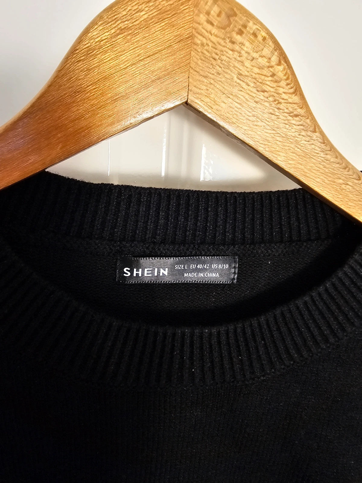 SHEIN black knit jumper with pearl studs and crew neck design.