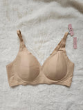 Oufali beige wireless bra seamless design with tag, no underwire for comfort.