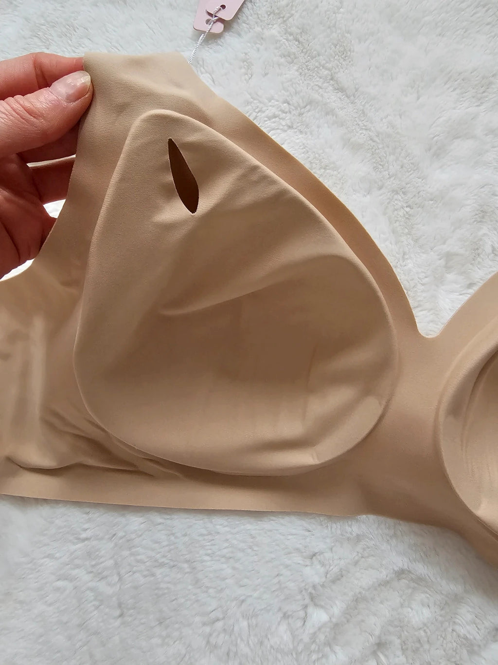 Oufali beige wireless bra seamless design with tag, no underwire for comfort.