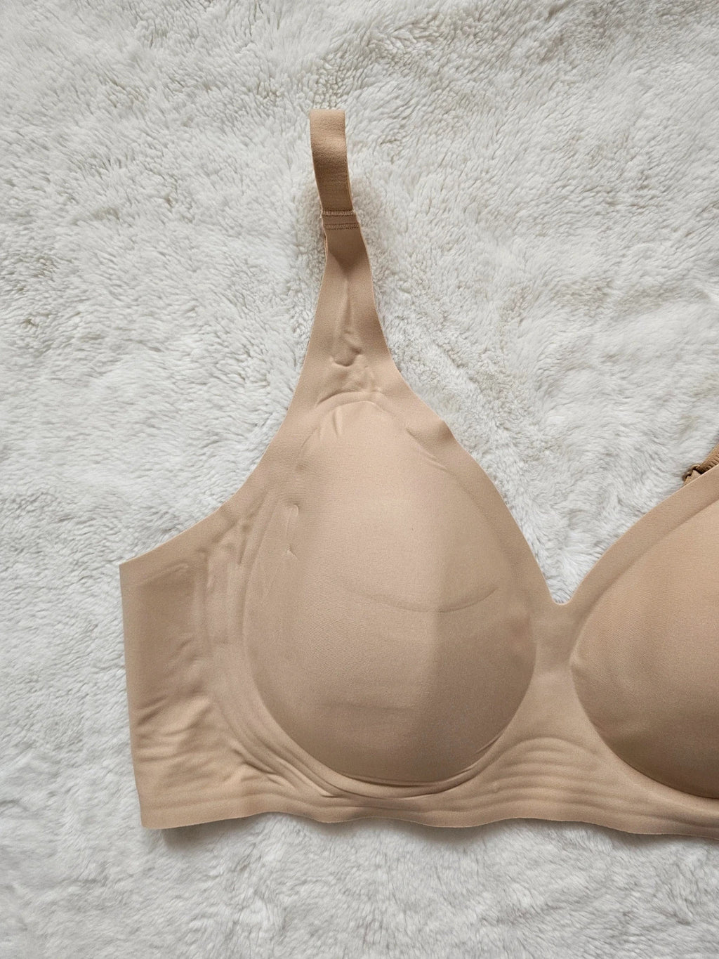 Oufali beige wireless bra seamless design with tag, no underwire for comfort.