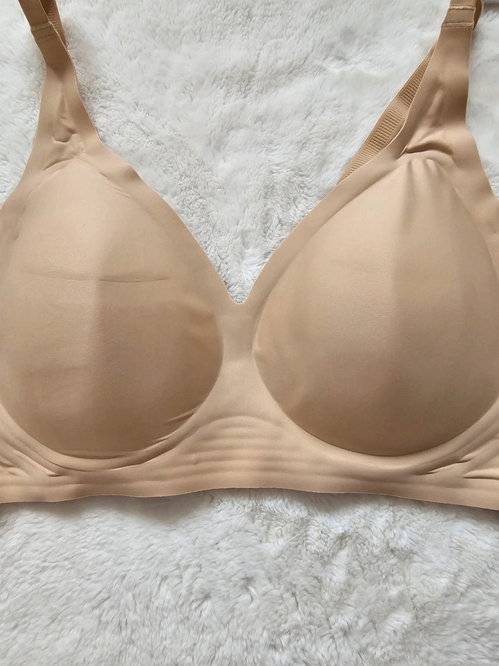 Oufali beige wireless bra seamless design with tag, no underwire for comfort.