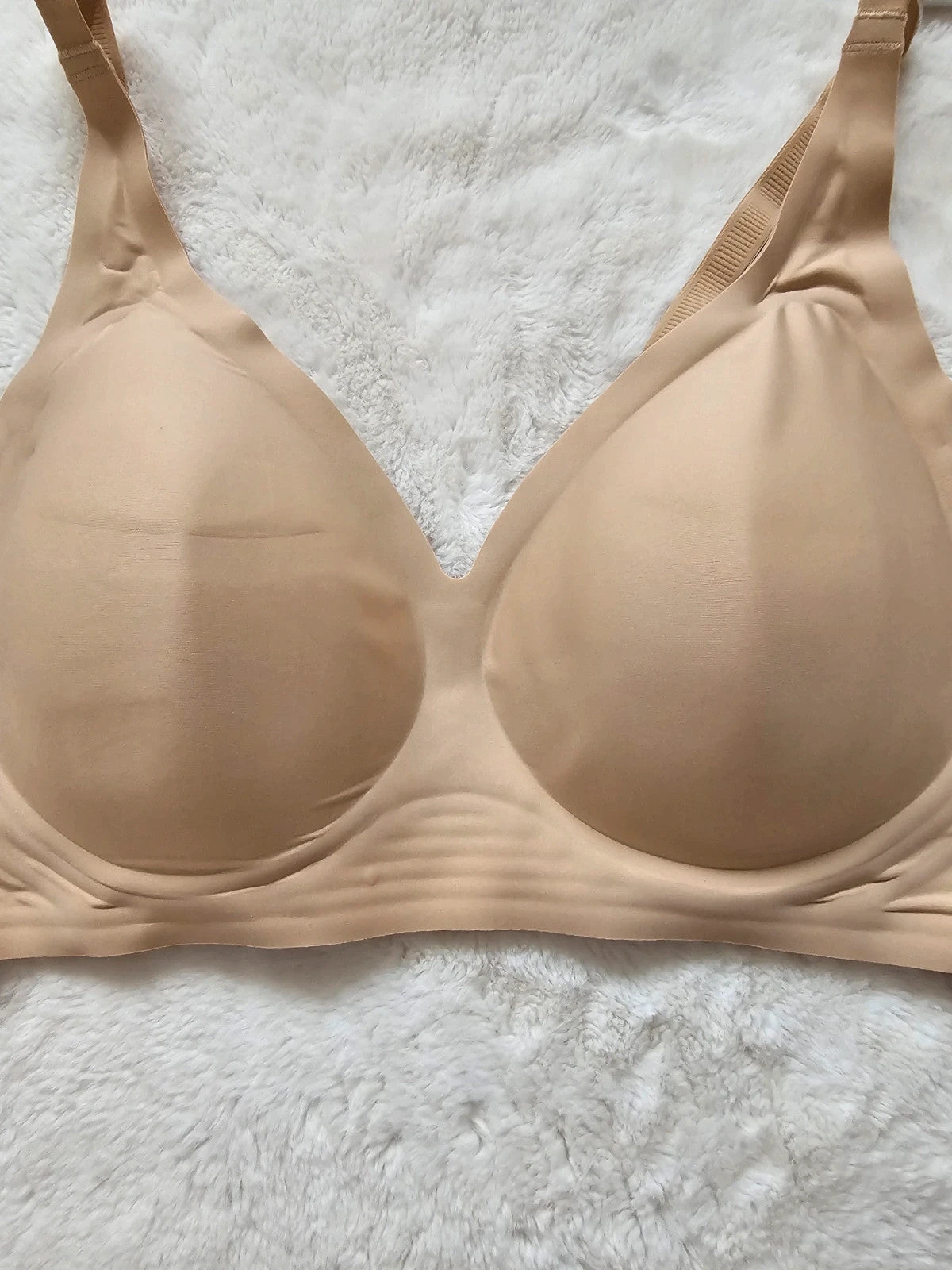 Oufali beige wireless bra seamless design with tag, no underwire for comfort.