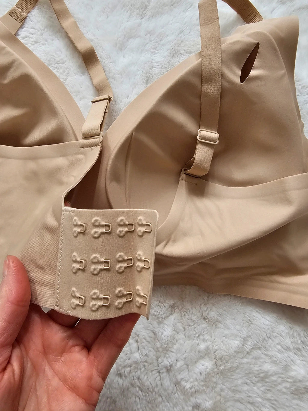 Oufali beige wireless bra seamless design with tag, no underwire for comfort.