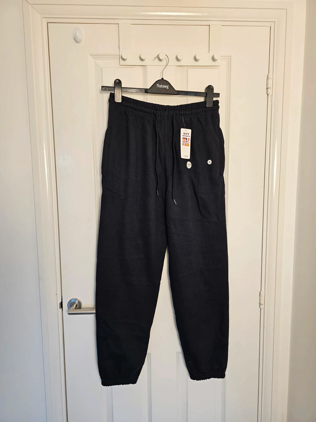Sports black joggers with elastic waist, drawstring, and side pockets, cotton blend.