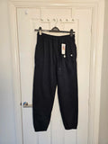 Sports black joggers with elastic waist, drawstring, and side pockets, cotton blend.