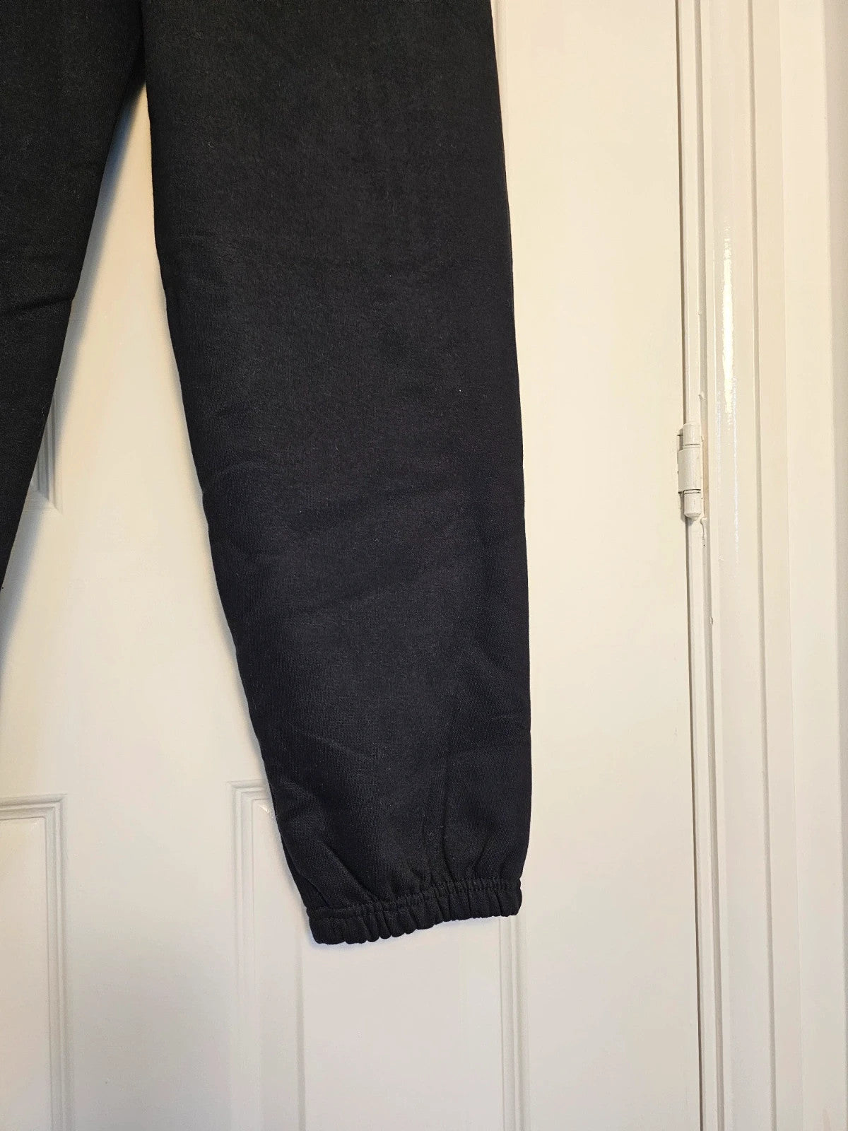 Sports black joggers with elastic waist, drawstring, and side pockets, cotton blend.