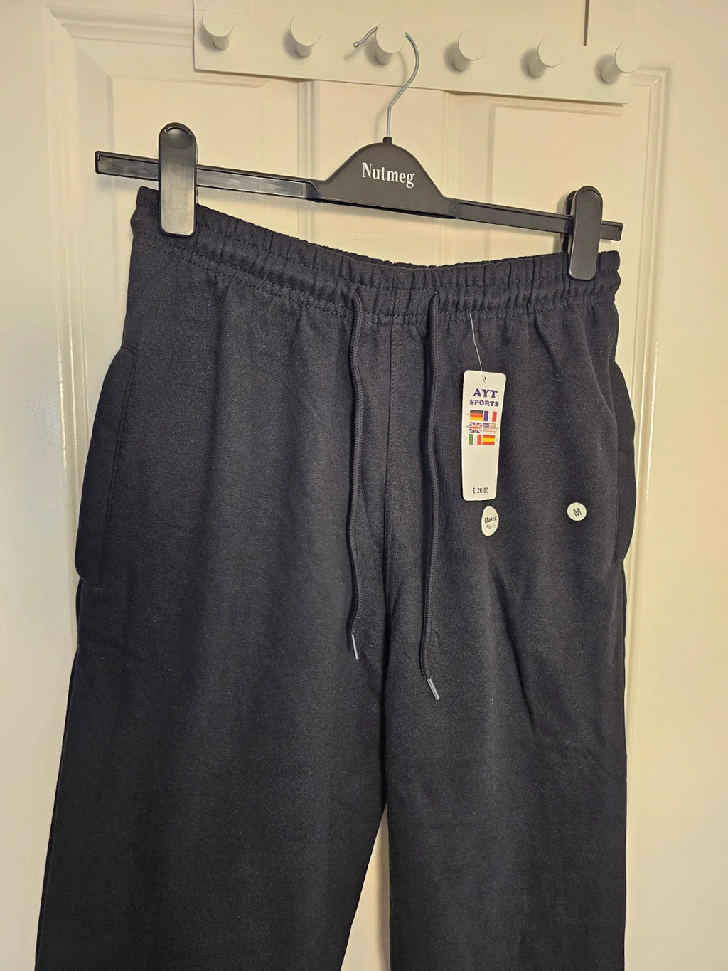 Sports black joggers with elastic waist, drawstring, and side pockets, cotton blend.