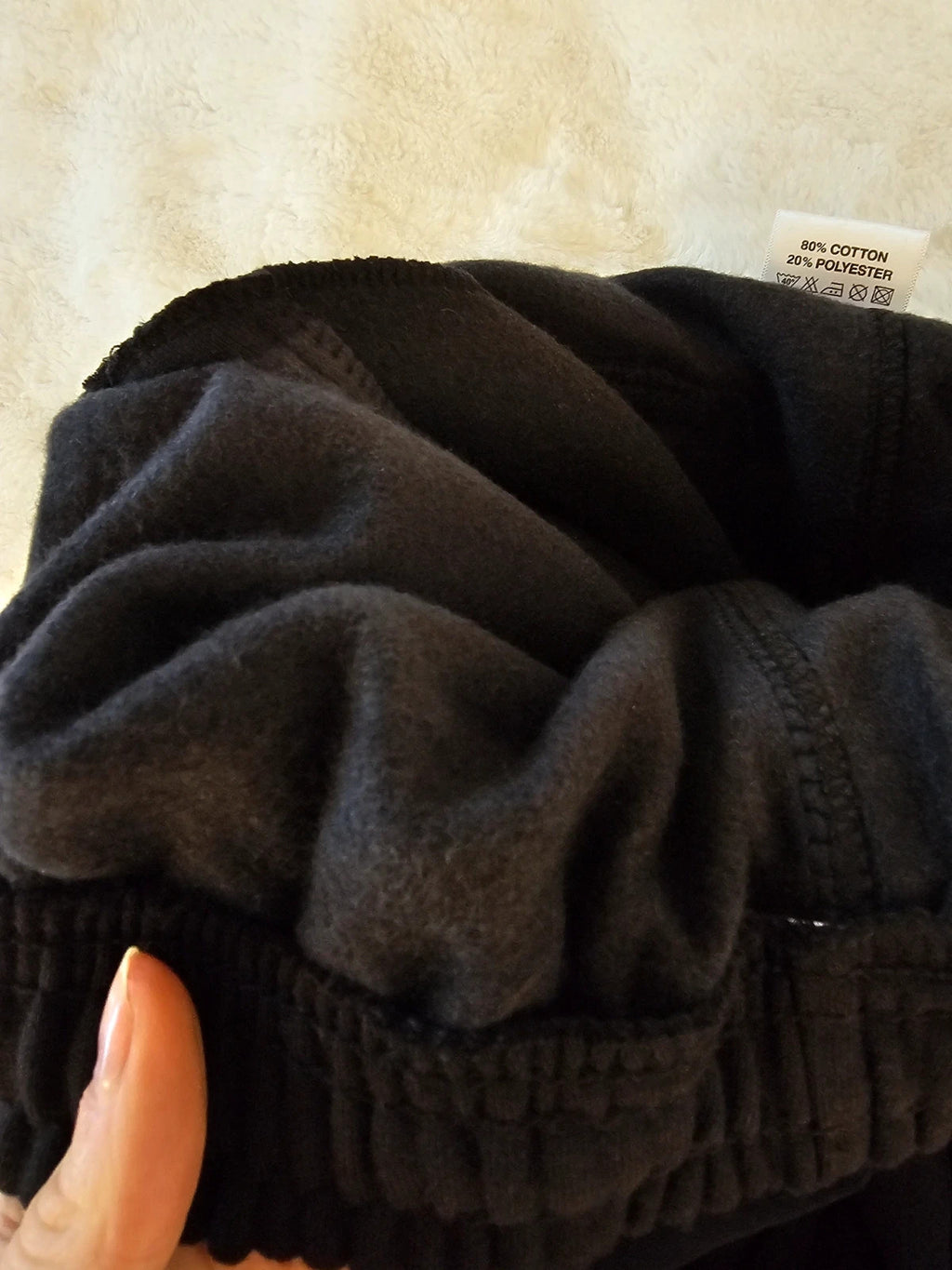 Sports black joggers with elastic waist, drawstring, and side pockets, cotton blend.