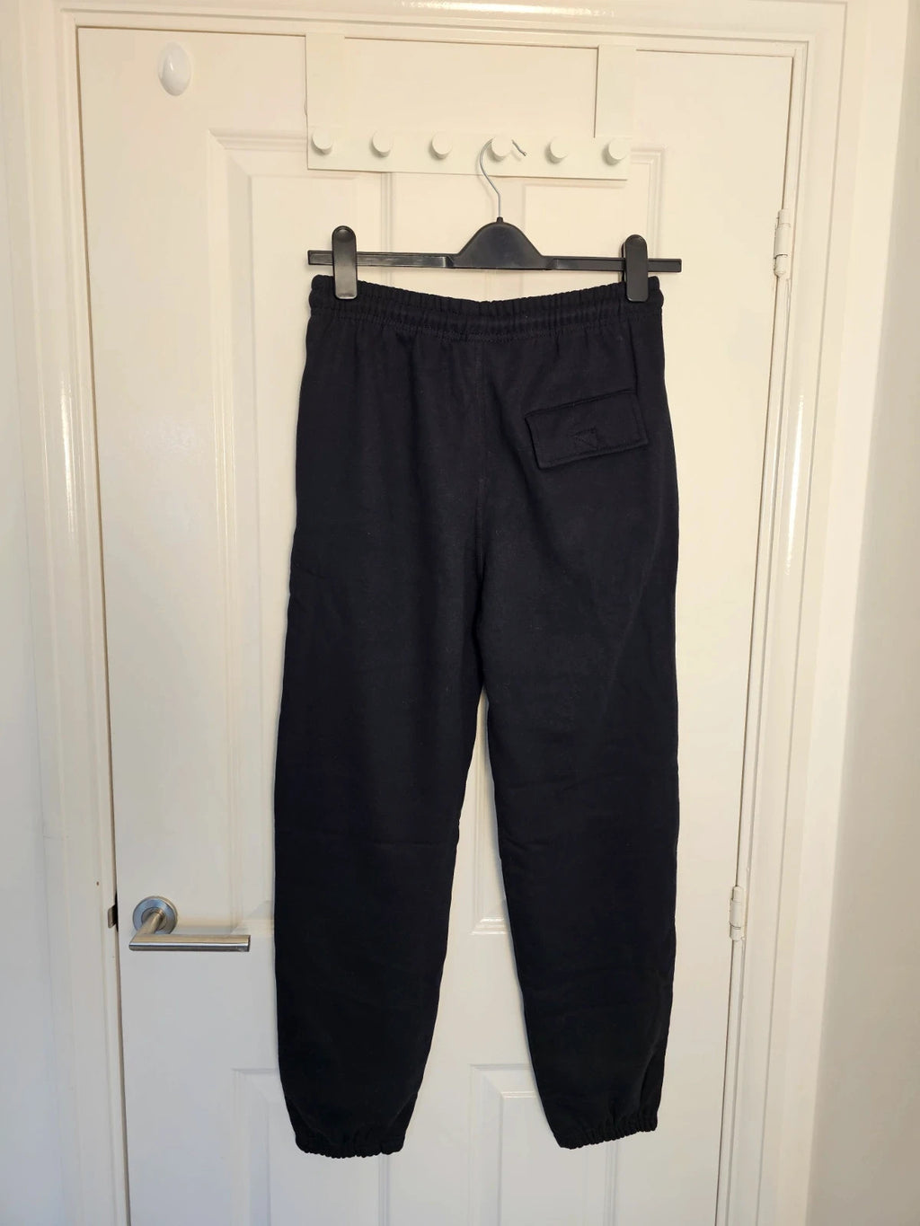 Sports black joggers with elastic waist, drawstring, and side pockets, cotton blend.