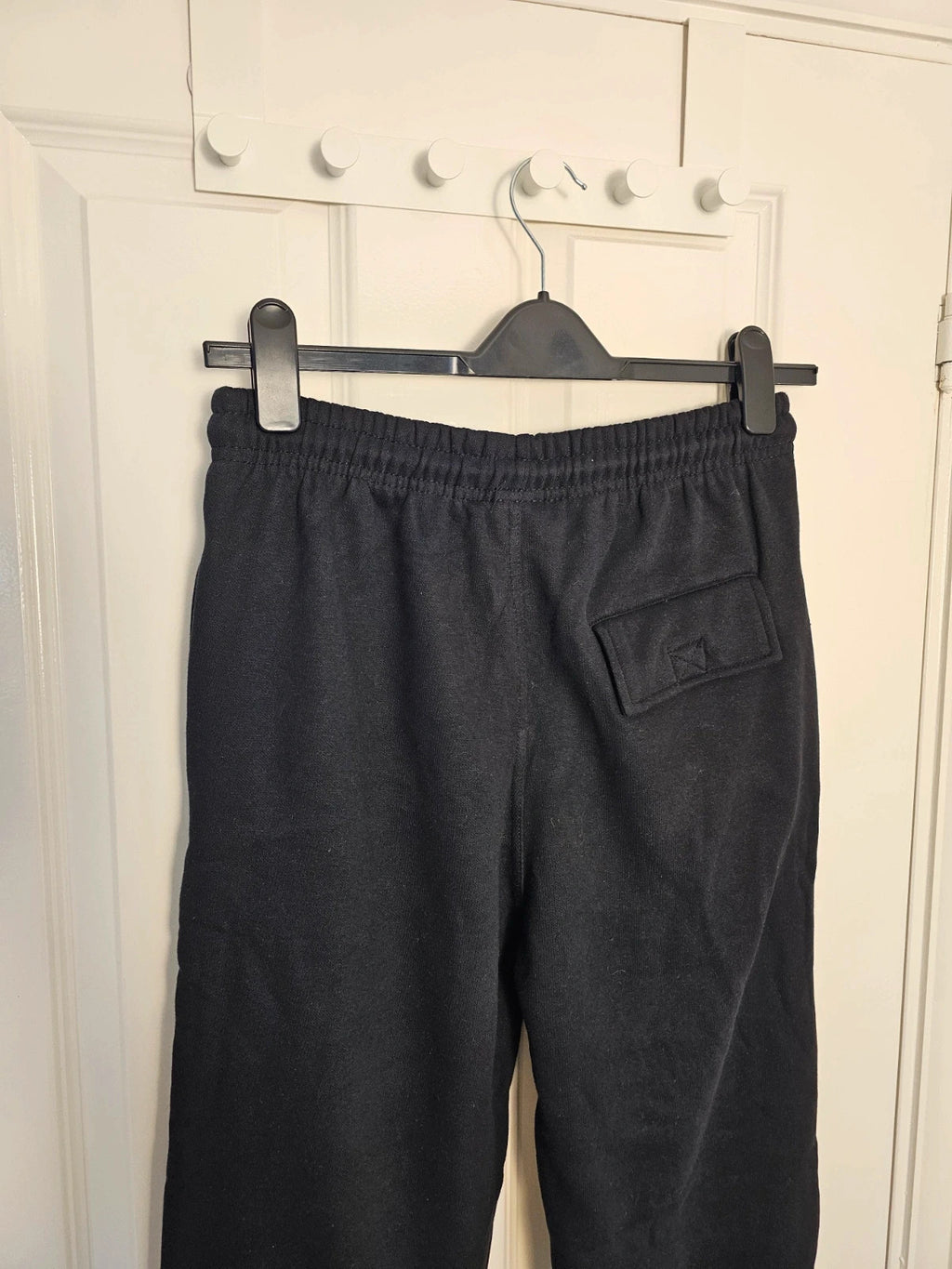 Sports black joggers with elastic waist, drawstring, and side pockets, cotton blend.
