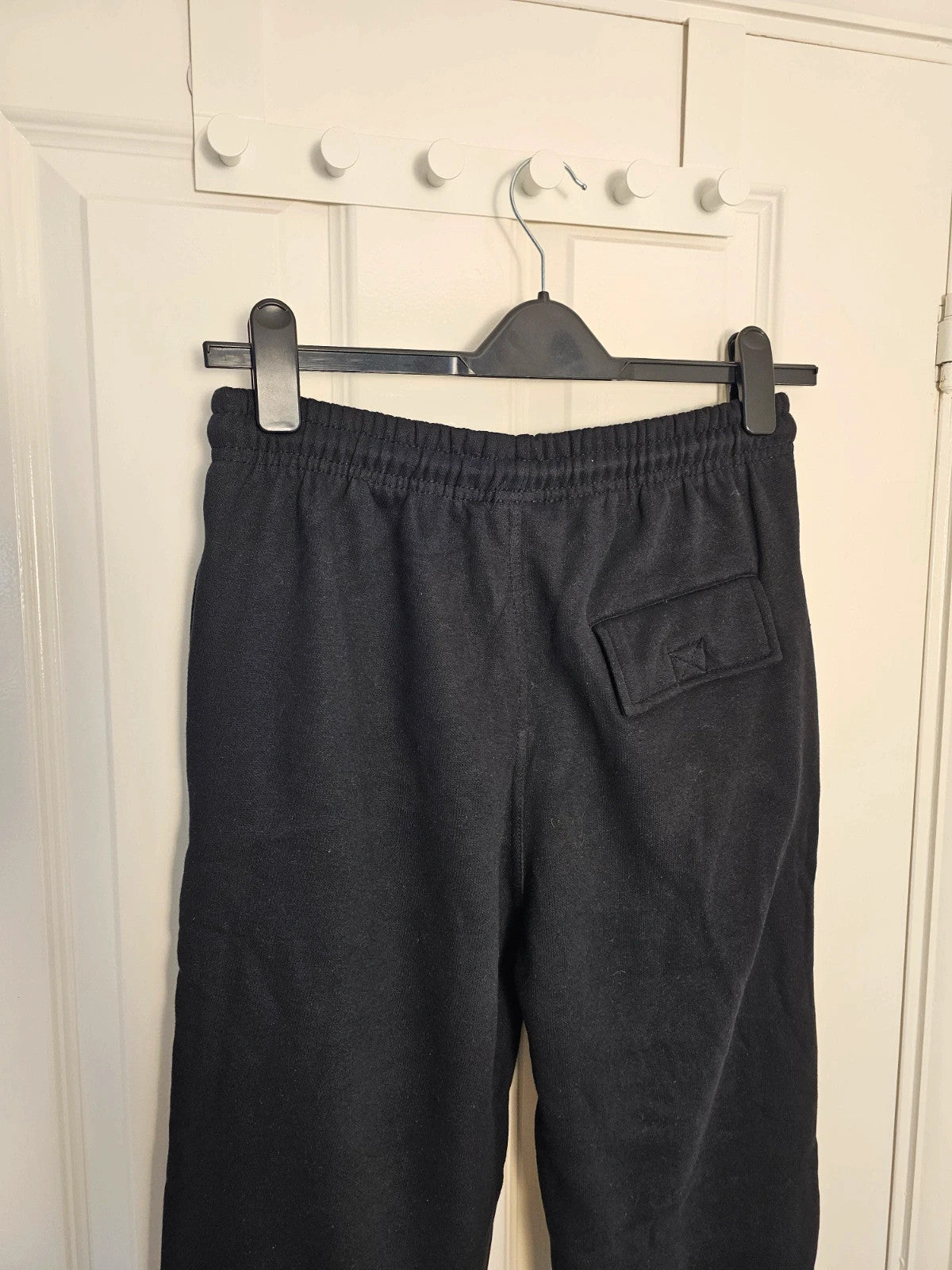 Sports black joggers with elastic waist, drawstring, and side pockets, cotton blend.