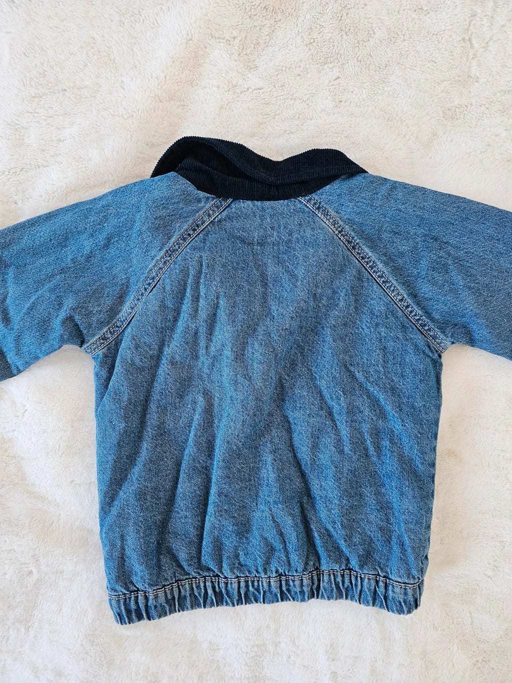 TU Kids blue denim sherpa jacket with outer collar, buttons, and pockets.